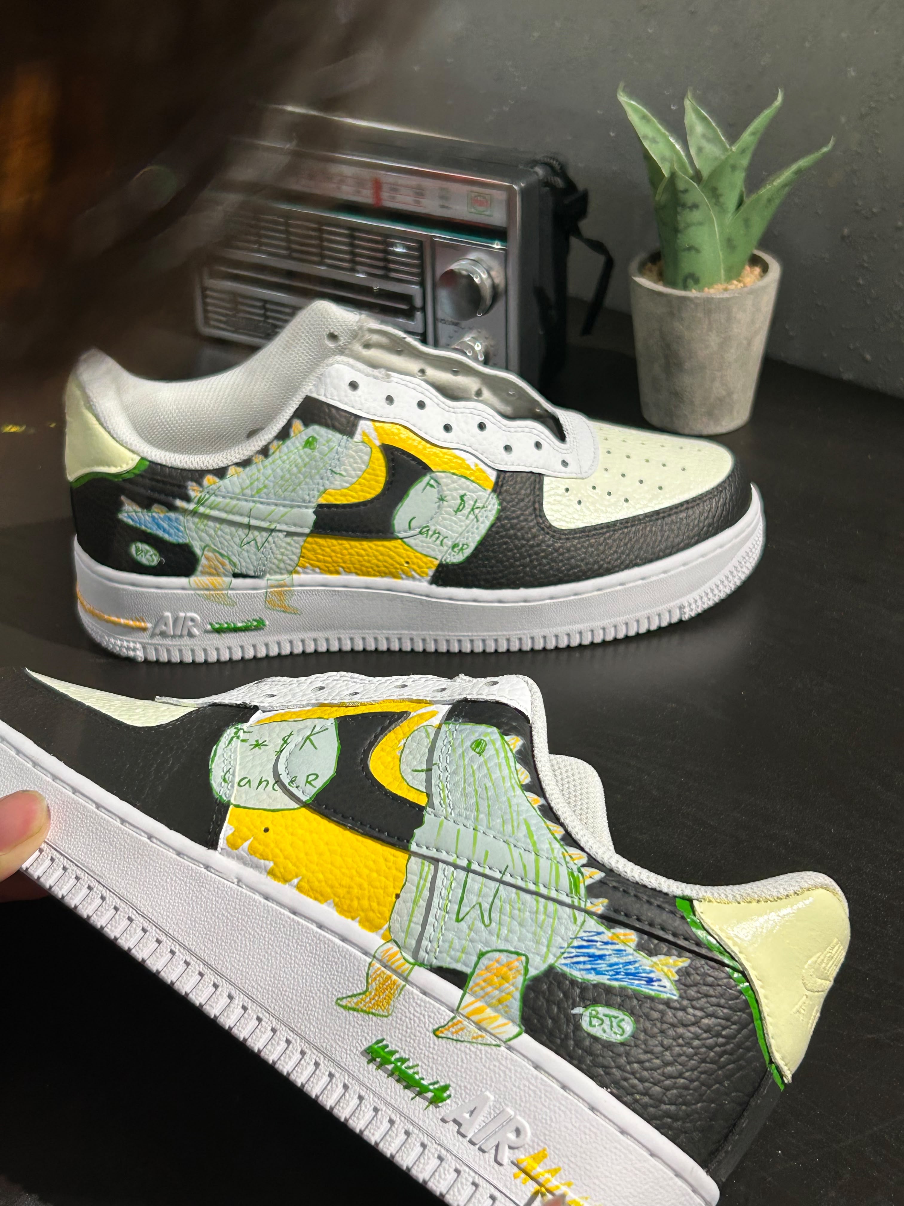 Side view of hand-painted DinoBoy shoe detail
